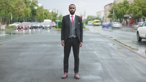 businessman in a suit on a rainy city street
