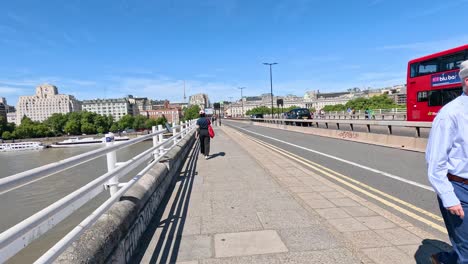 people walking and vehicles moving on bridge