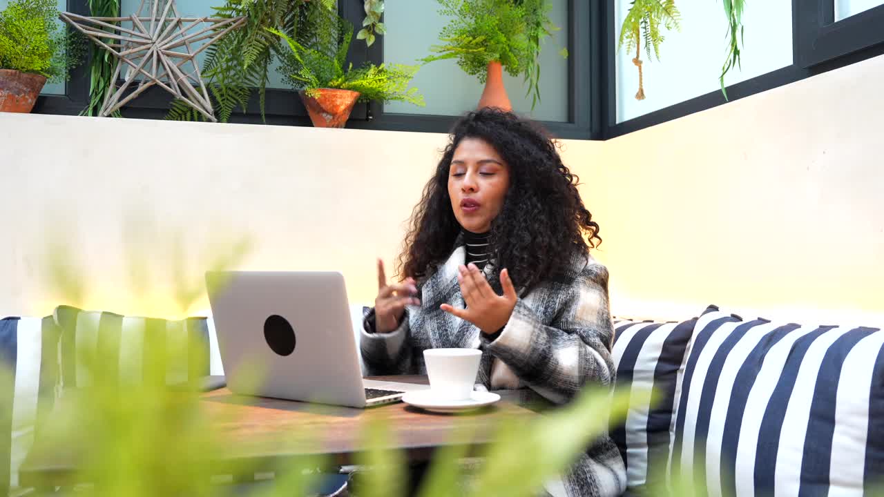 Woman on Video Call at Cafe