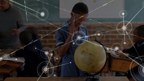 Animation-of-network-of-connections-with-icons-over-african-american-boy-with-globe-at-school