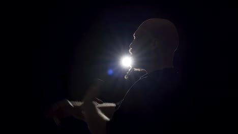 a rapper delivering a performance during the night - close up