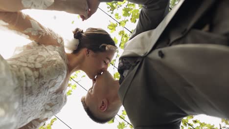 lovely newlyweds caucasian bride embracing groom in park making kiss, wedding couple family hugging