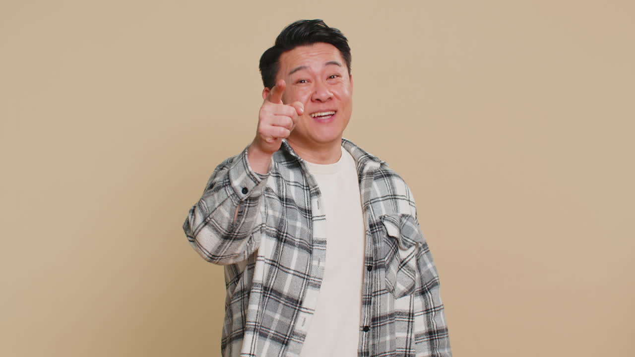 Smiling happy man pointing forward to camera choosing lucky victory winner indicating promotion