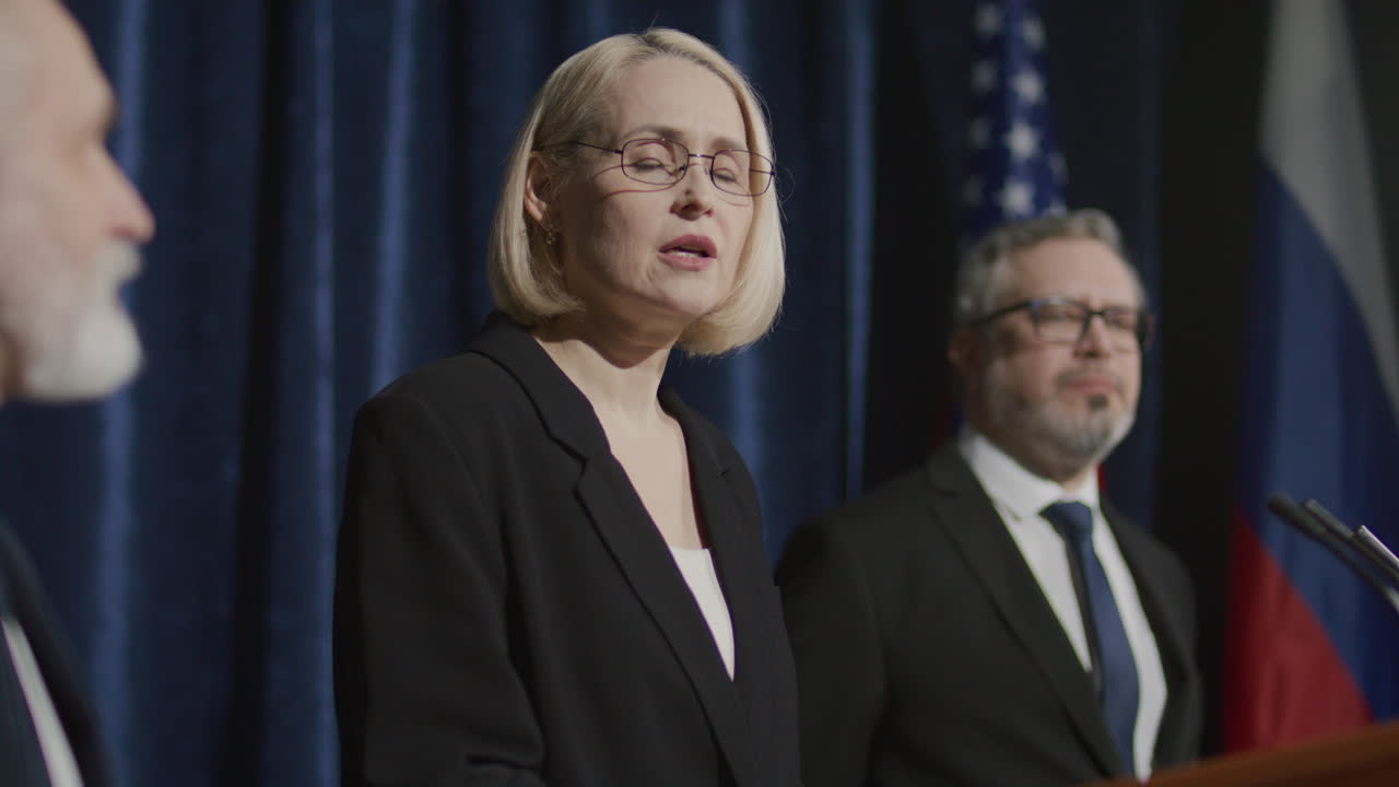 Female Politician Answering Questions during International Press Conference