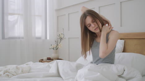 Woman-waking-up-and-having-pain-in-shoulder-and-neck.-Woman-waking-up-and-having-pain-in-shoulder-and-neck