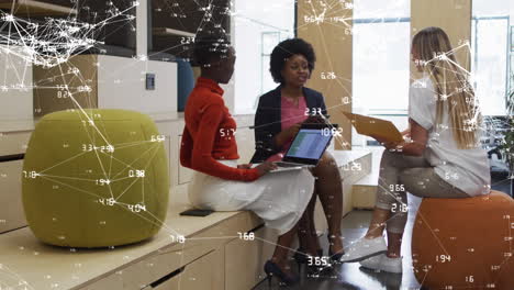 Network-of-connections-against-diverse-female-office-colleagues-discussing-together-at-office