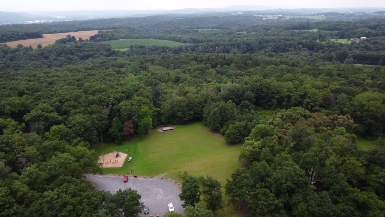 una vista aérea de un pequeño parque en la cima de una colina cubierta de árboles