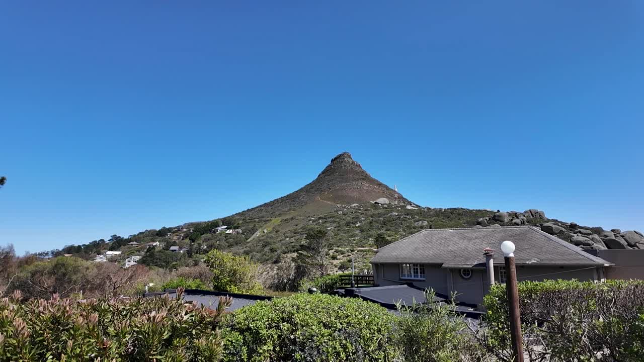 Clear, sunny view of Lion's Head mountain from a residential area in Cape Town, South Africa.