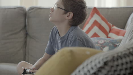 kid playing video games on the couch