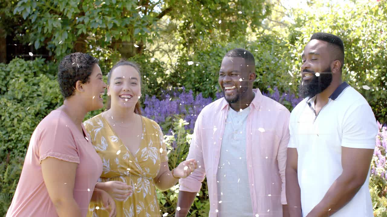 Woman in yellow leading singing, friends reacting in garden, confetti drifting across group, ads