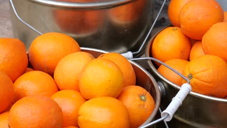 oranges in metal buckets