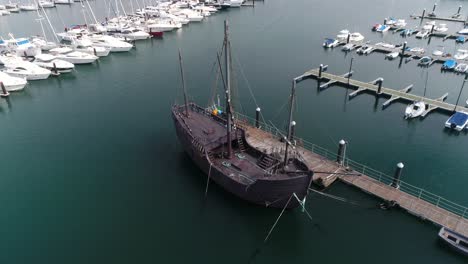Ancient-Boat-in-Port-of-Baiona-Aerial-View