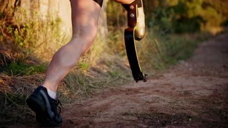 woman with prosthetic leg running in nature