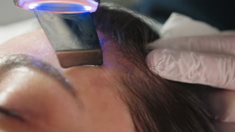 close up of skin care specialist gliding electric massager across client skin during spa treatment showcasing relaxing therapeutic massage under soft natural lighting for rejuvenation