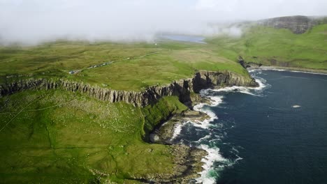 clouds form above loch moor overlooking epic scottish highland coastal cliffside