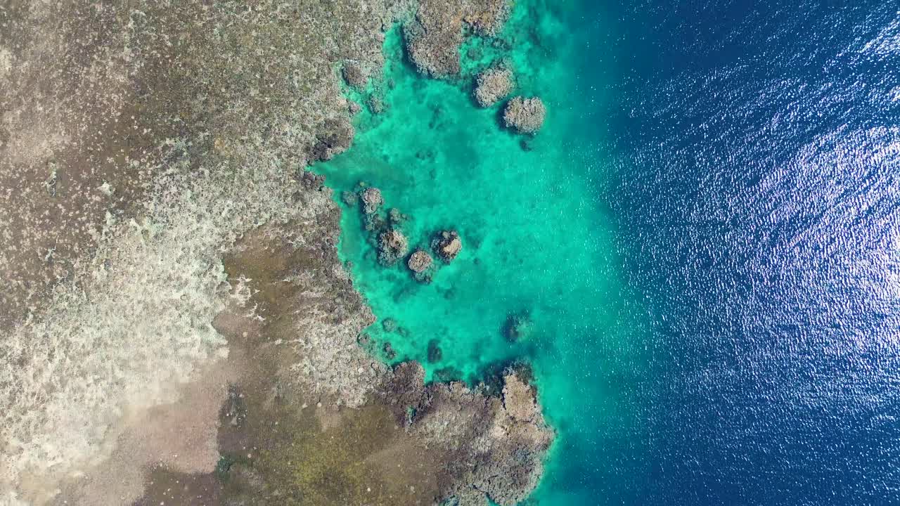 Aerial drone shot of crystal clear rocky coastline snorkel diving spot coral reef inlet water ocean holiday trip Hideaway Mele Island Port Vila Vanuatu 4K
