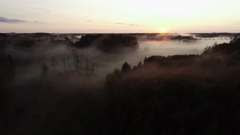 Flight-above-sunset-fog-in-golden-hour-after-rain