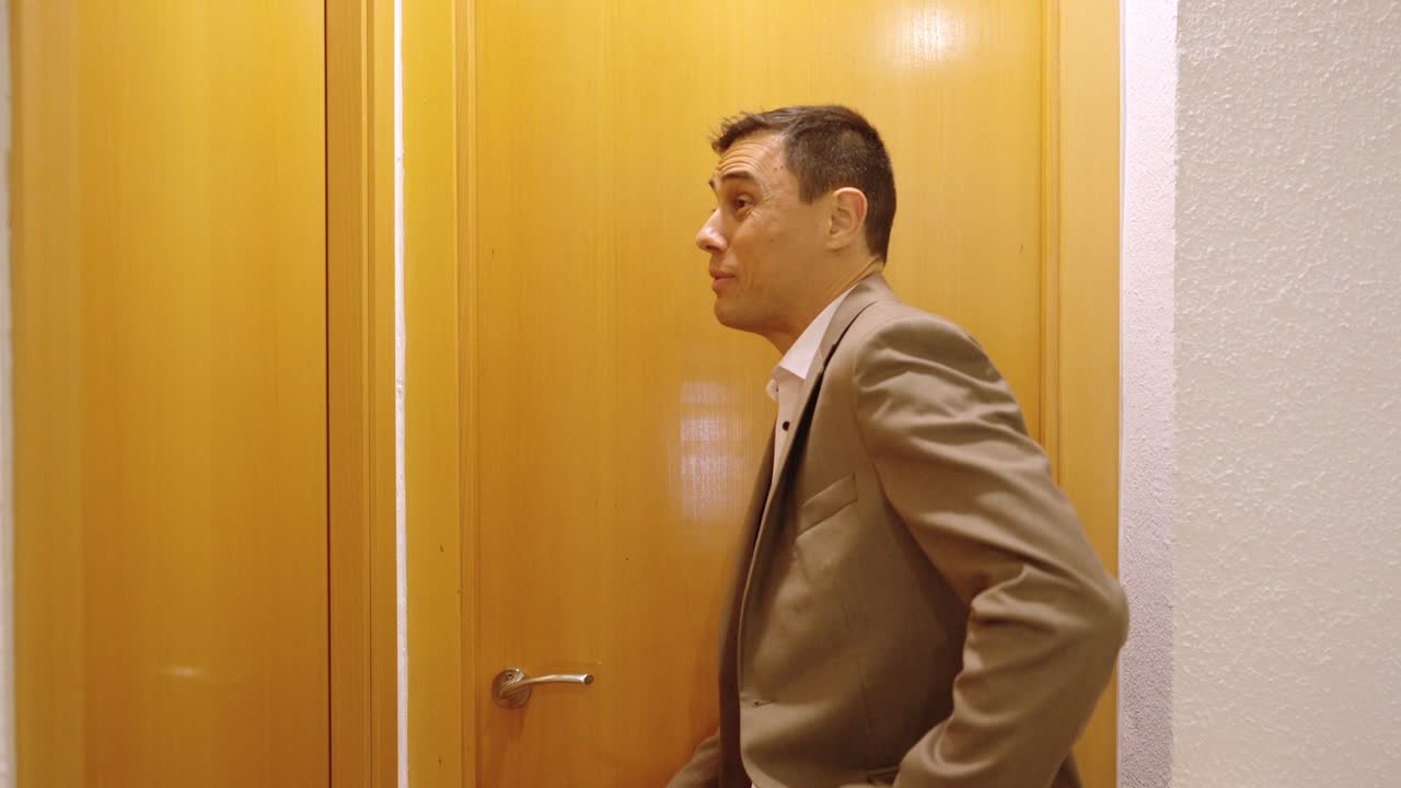 Impatient businessman waiting for wife in bathroom