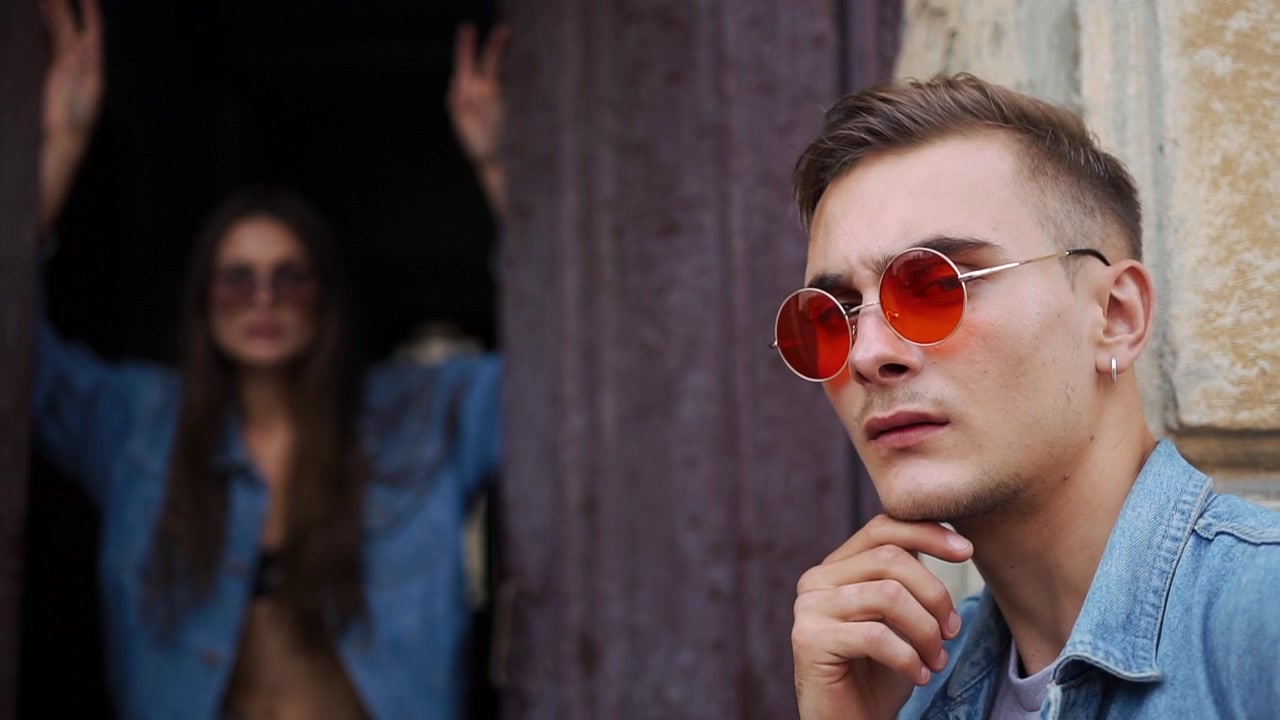 Young Man Wearing Red Sunglasses Posing Outdoors