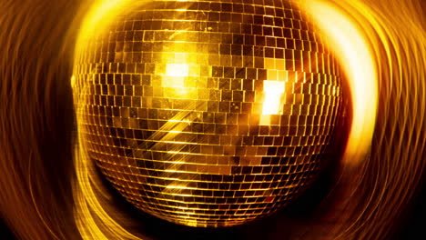 a spinning gold mirror ball in night club