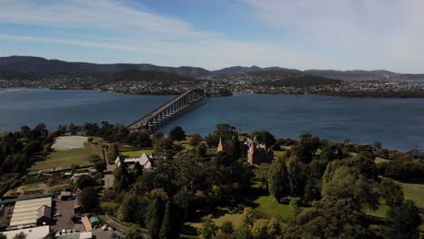 Hobart-Bridge-Tasmania-Bay-Australia-drone-Panning-view-of-nature,-water,-cars-and-trees-in-4k
