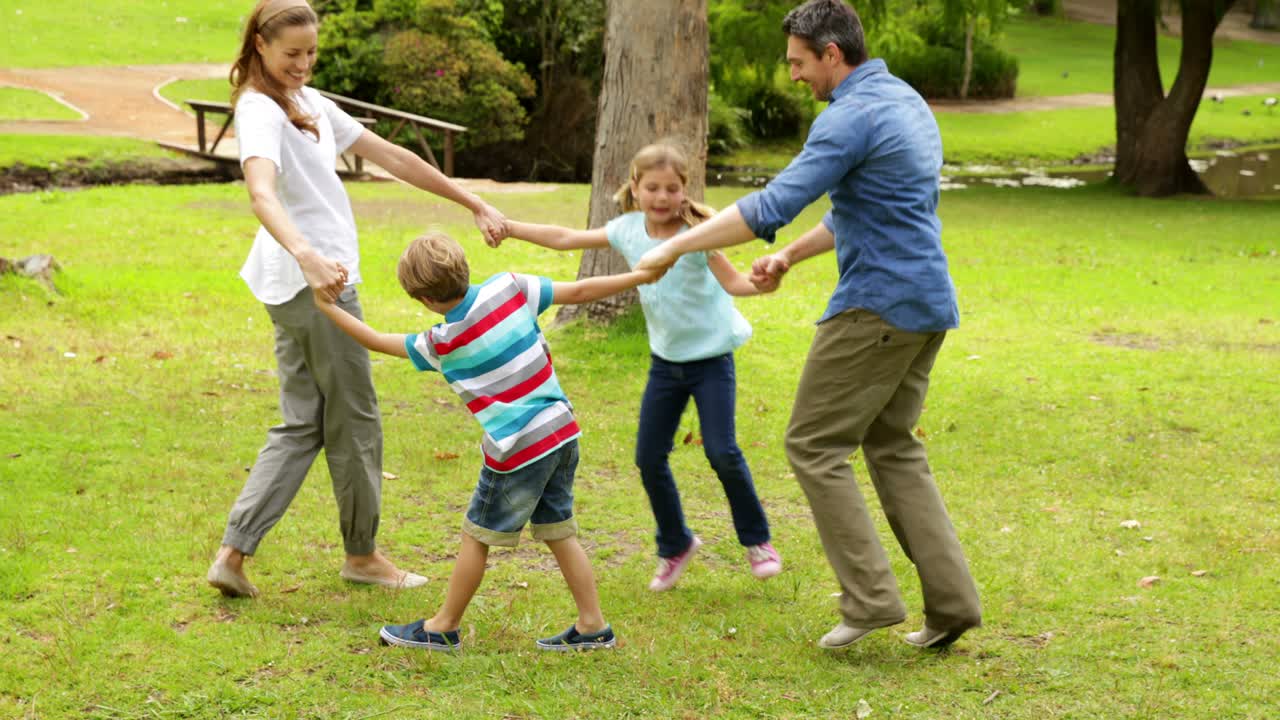familia feliz jugando anillo una rosa en el parque juntos