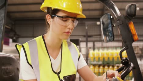 worker examining while writing on clipboard