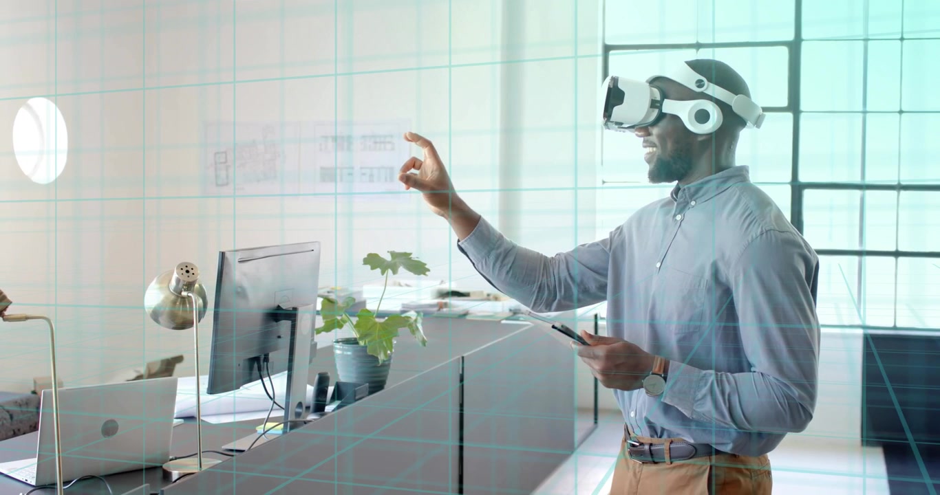 Man standing at desk wearing VR headset pinching resizing hologram over grid exploring interface