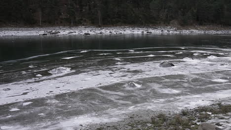 partially frozen lake in the pyreneese range in andorra