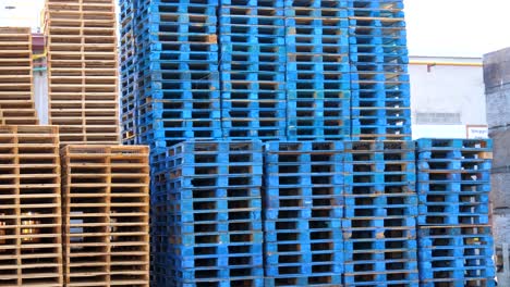 stack of industrial wood pallets outside a factory