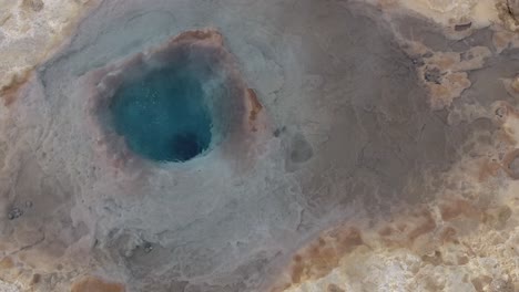 Aerial-drone-shot-of-Strokkur,-a-fountain-geyser-located-in-Iceland