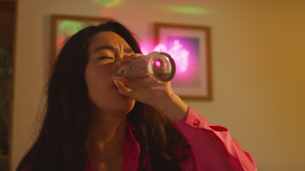 mujer sentada en el sofá después de beber alcohol en una fiesta de casa tomando medicamentos para la resaca 2