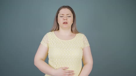 young woman experiencing stomachache.