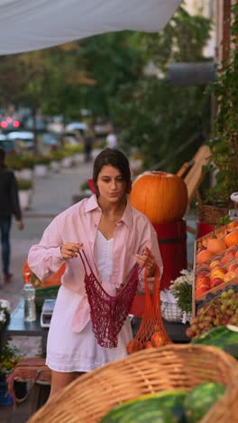 woman shopping for fruits and vegetables at a street market