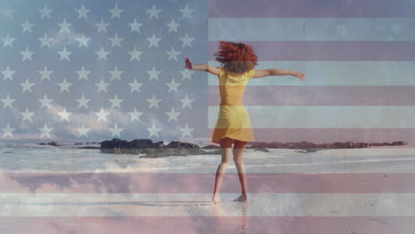 Animation-of-american-flag-and-clouds-over-african-american-woman-dancing-on-sunny-beach