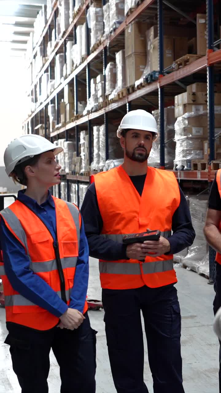 Warehouse workers in safety gear