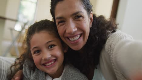 Portrait-of-happy-mixed-race-mother-and-daughter