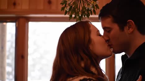 a heartwarming moment of connection between two people in a cozy setting, capturing the intimacy of their affection as they gaze into each other's eyes