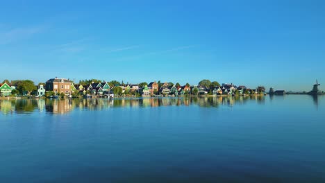 old traditional wooden houses along the river at the zaanse schans, koog aan de zaan, netherlands