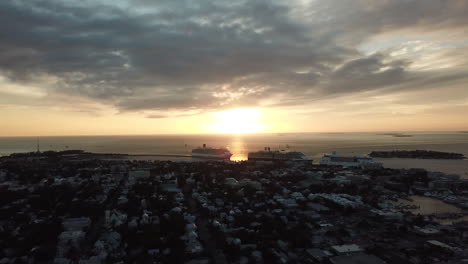 cruise ships docked at key west cruise ship port during golden hour sunset from vantage point of drone