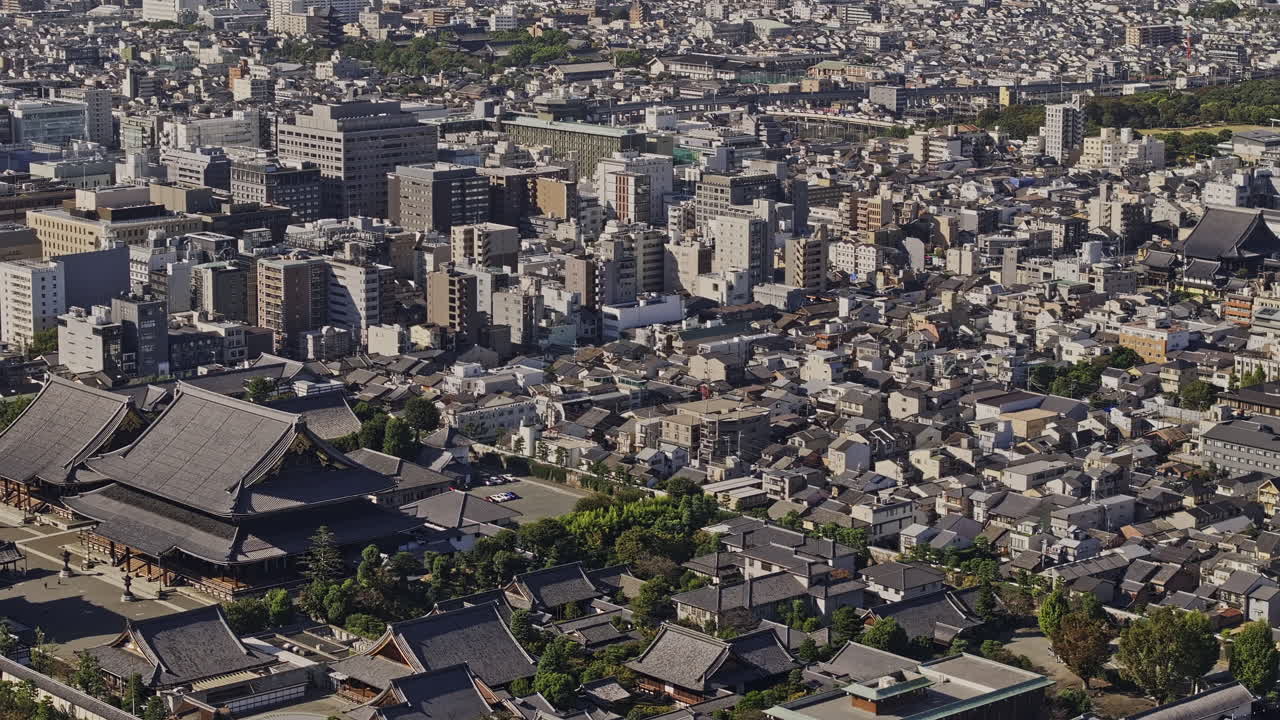 Kyoto Japan Aerial v45 zoomed tracking flyover Shimogyo ward capturing Tokiwacho temple, observation tower, train station and views of downtown cityscape - Shot with Mavic 3 Pro Cine - Oct 8th 2023