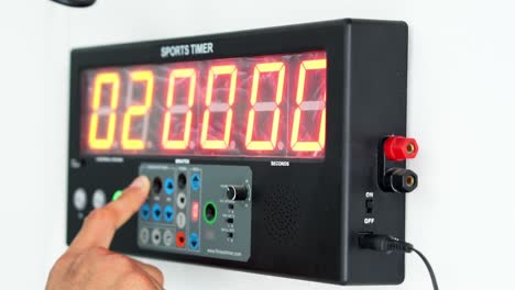 male hand setting sports timer