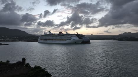 Two-cruise-ships-docked-in-harbor-of-Puerto-Plata-at-sunset,-Dominican-Republic