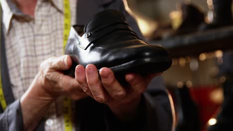 Shoemaker-examining-a-shoe