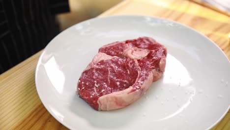 raw steak seasoned with salt