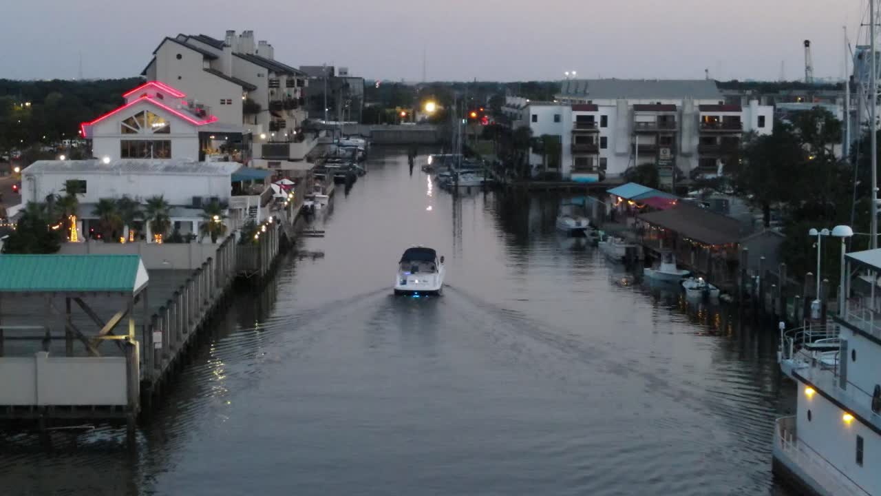 Speed Boat Sailing Passing By Coastal Structures At West End Of Lakeshore Drive, New Orleans, Louisiana USA. Aerial