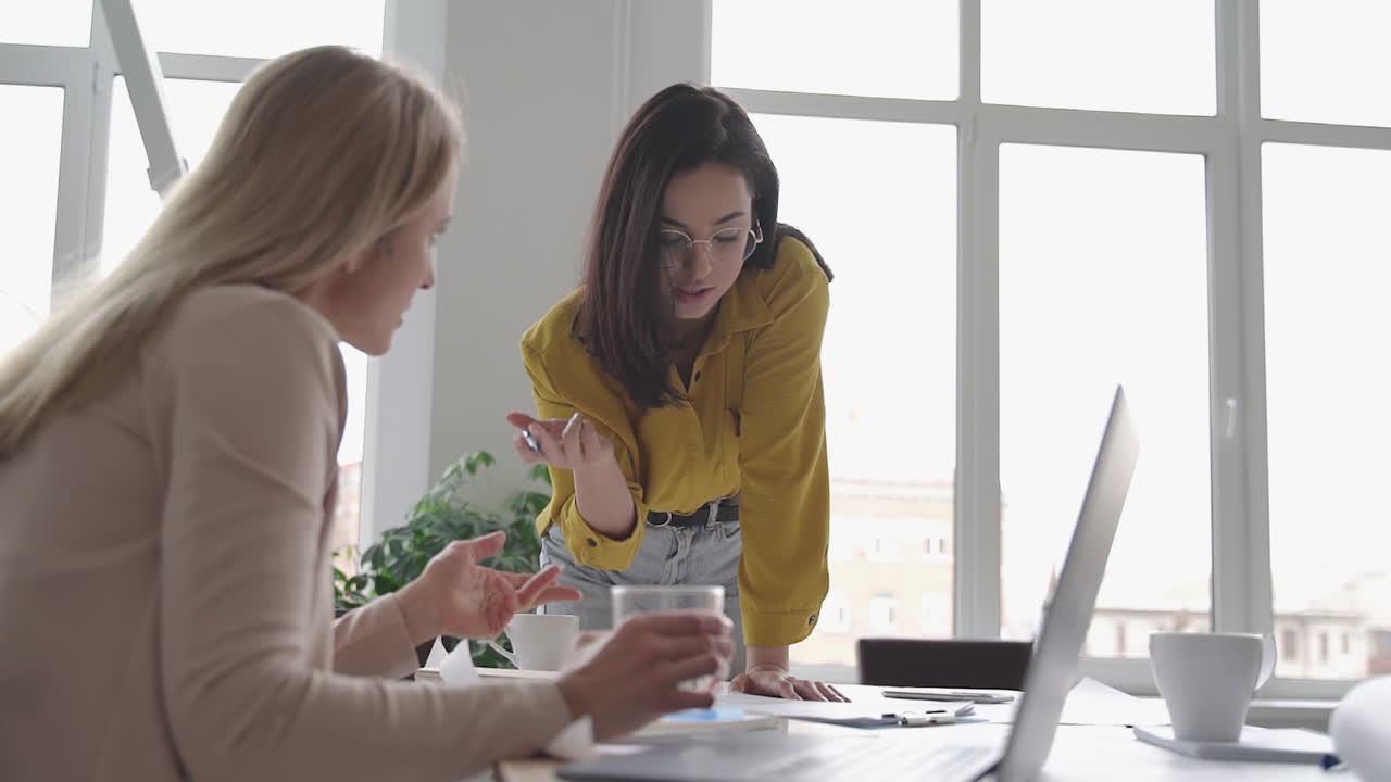 Females in a business meeting. Teamwork discussing in the office. International Women's Day.
