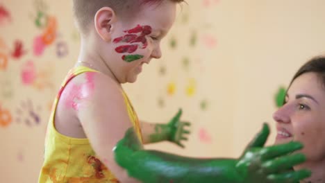 Slow-motion-and-close-up-shot-of-a-happy-little-boy-giving-tight-hugs-to-his-beloved-mother-while-they-are-playing-and-leaving