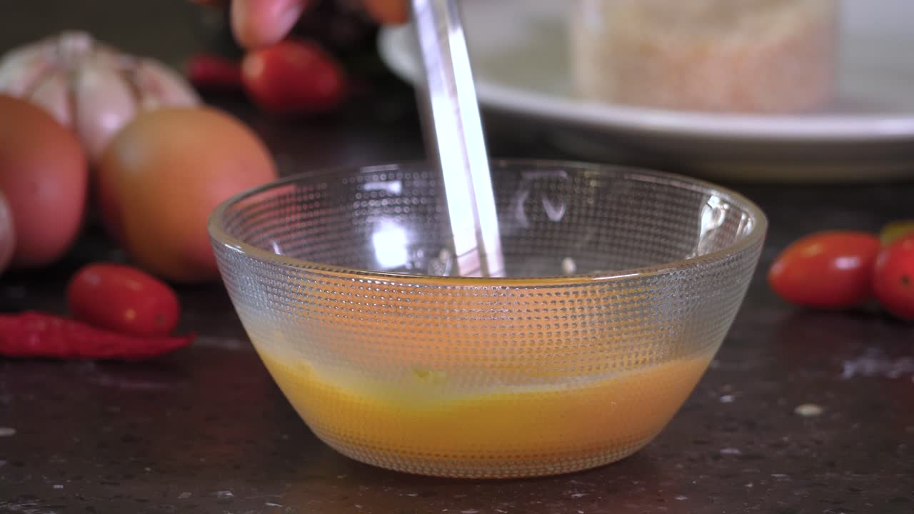 Omelet home cooking whisking egg with chopsticks up-close Japanese Tamagoyaki