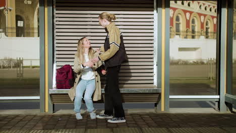 Young-woman-sitting-at-bus-stop